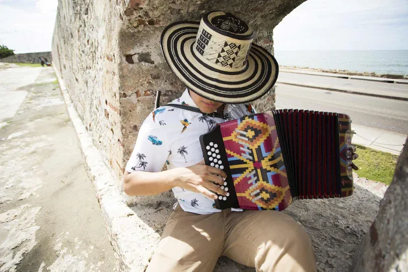 A vallenato accordion player leaning against a wall. Valledupar is also part of the García Márquez route