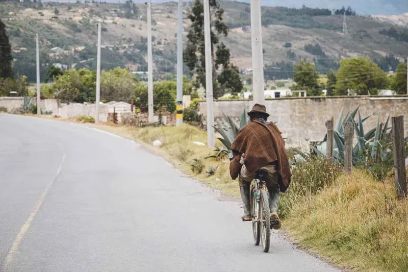 Peasant biking up the hill in a town near Bogotá