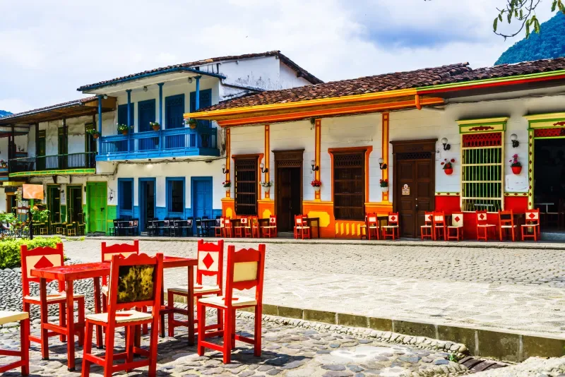 A man walking through the colorful streets of Jardín, Antioquia.