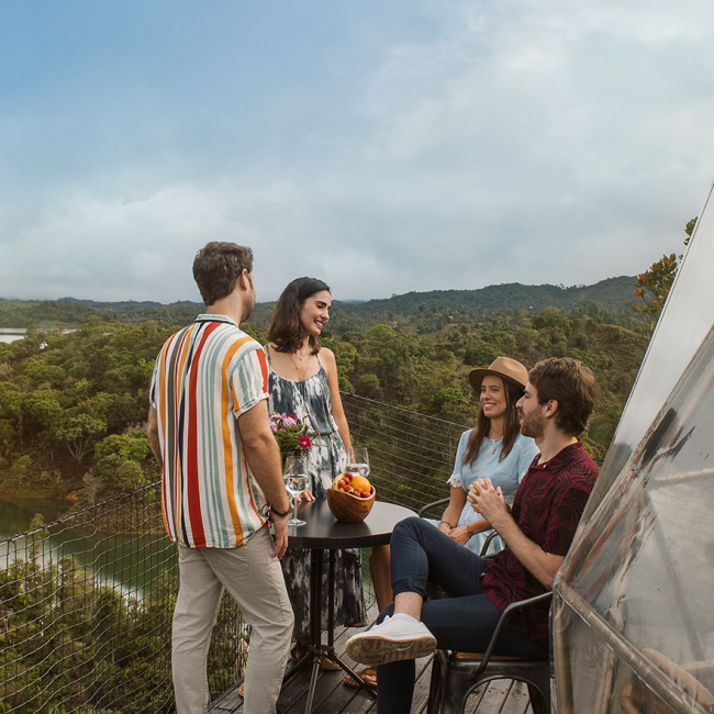 Friends enjoying glamping surrounded by a natural landscape – Colombia Travel