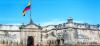 Walls of Cartagena with Colombia flag and blue sky